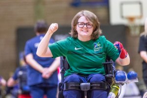 Claire Taggart celebrating with arms in the air after winning a game of boccia